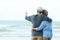 Asian Lifestyle senior couple hug on the beach happy in love romantic and relax time.Â  Tourism elderly family travel leisure and